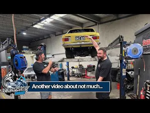 Nugget Garage video thumbnail showing a workshop and yellow car